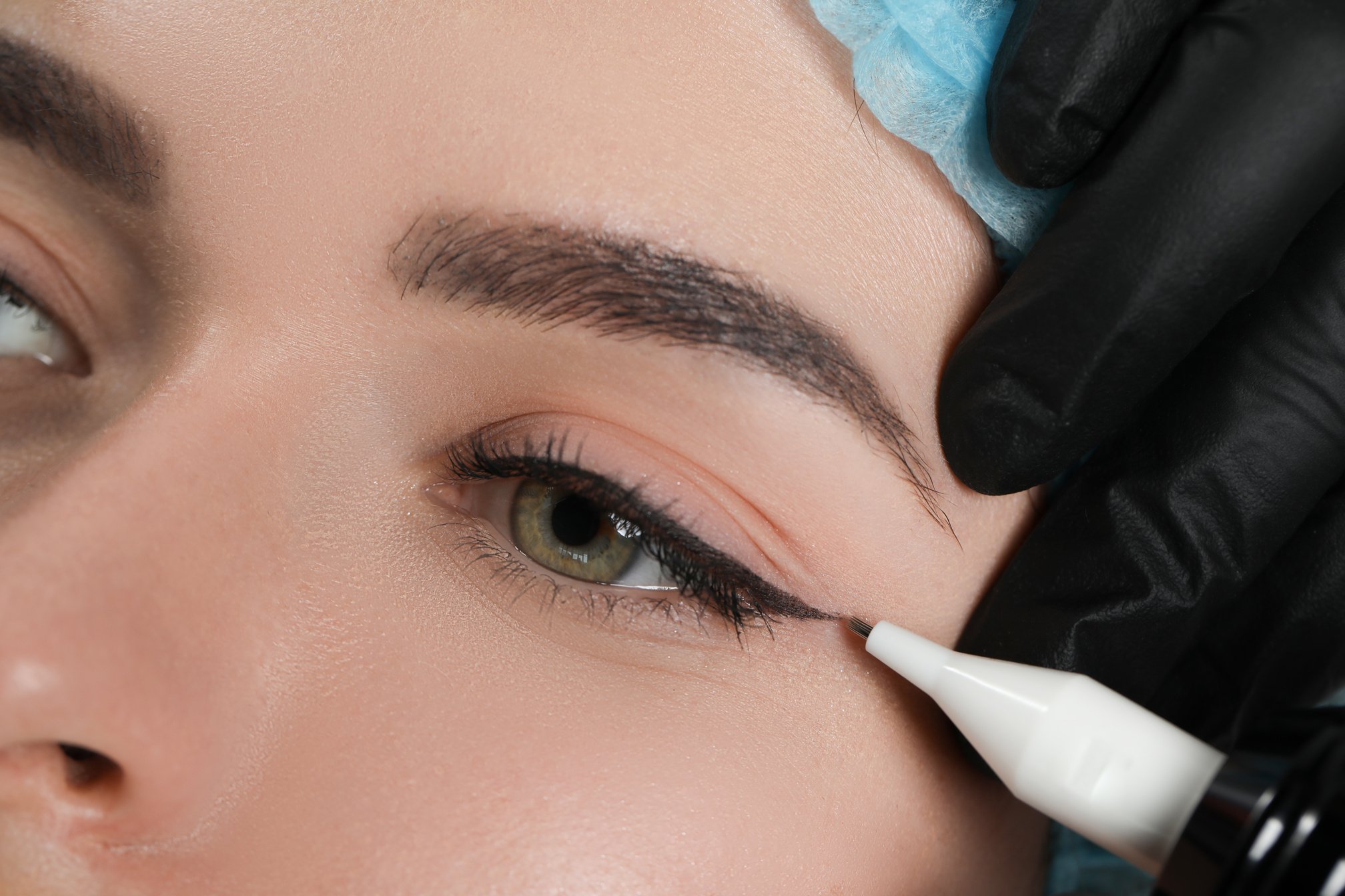 Young Woman Undergoing Procedure of Permanent Eye Makeup, Closeu